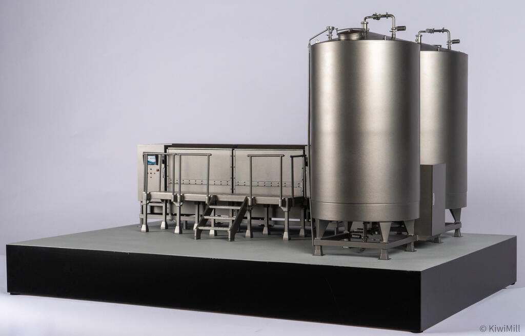 Low right-side angle of the two water tanks on their frames, with the cook tank and handrails in the background